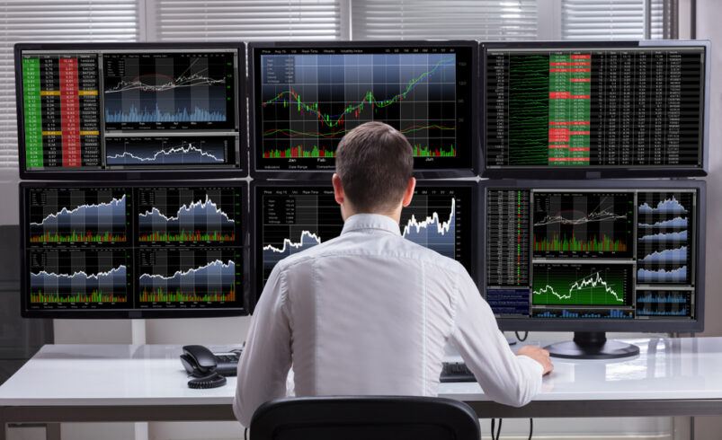 SideViewOfAYoungMaleStockMarketBrokerAnalyzing